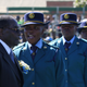 Zimbabwe’s President Robert Mugabe walks past police officers during a graduation ceremony in Harare May 29,2014.